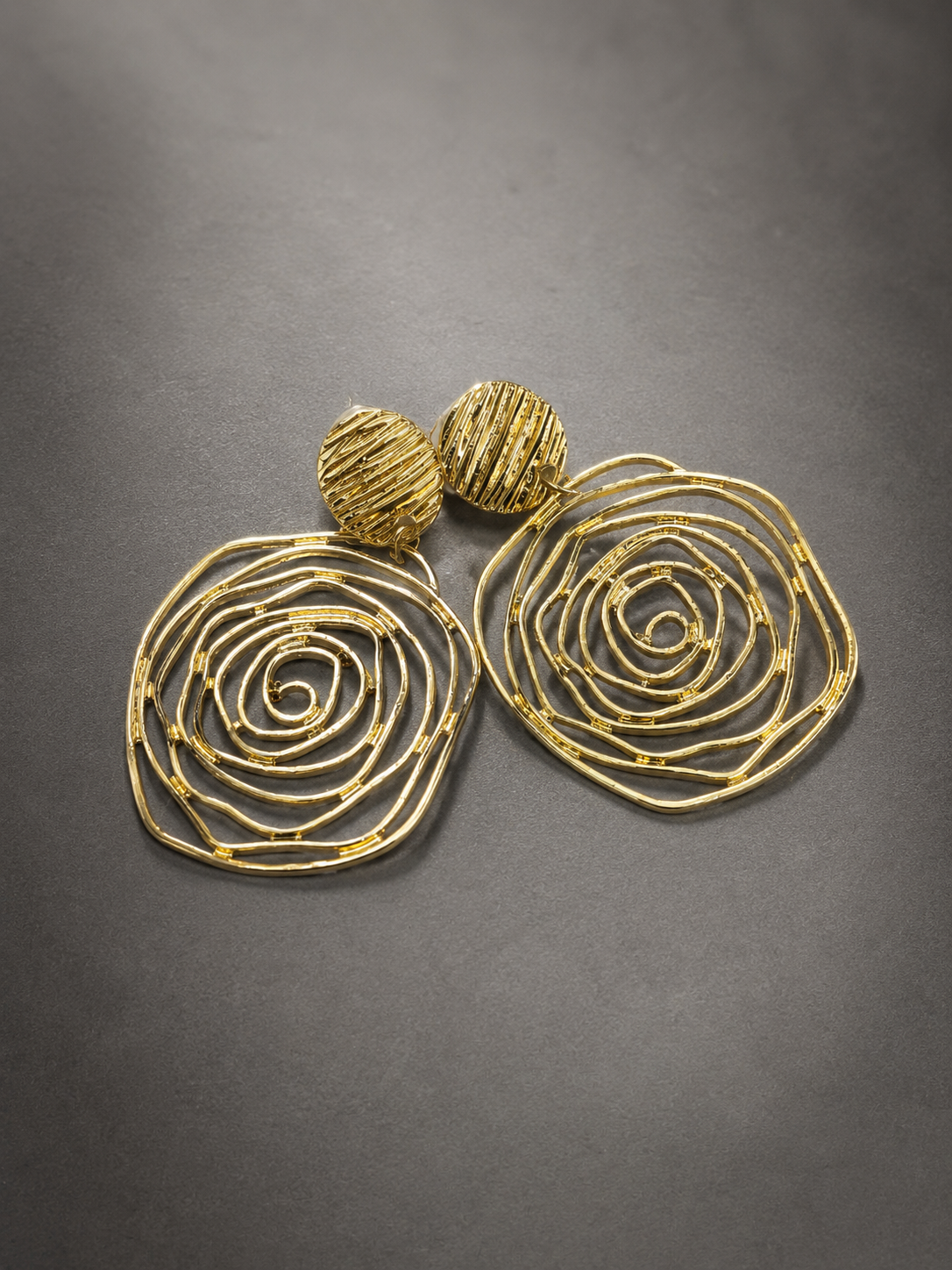 Contemporary gold spiral drop earrings, front view