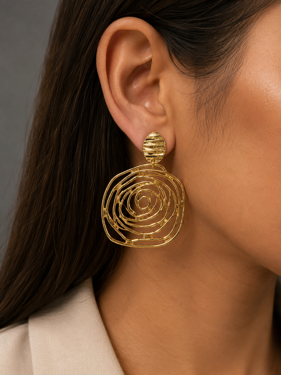 Gold-tone layered spiral earrings shown from the side
