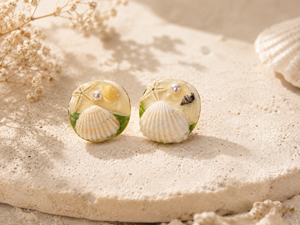 Seashell and pearl embellished stud earrings, front view