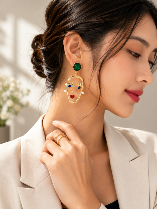Gold-tone face motif earrings with emerald green and multicolour accents
