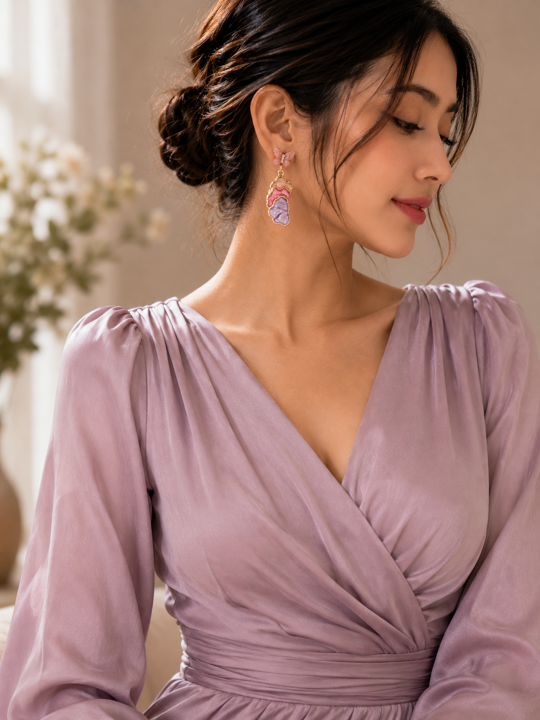 Blush butterfly drop earrings showing pastel sculptural detail