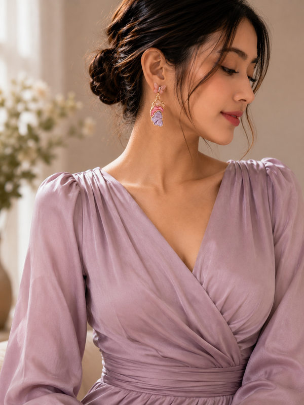 Blush butterfly drop earrings showing pastel sculptural detail