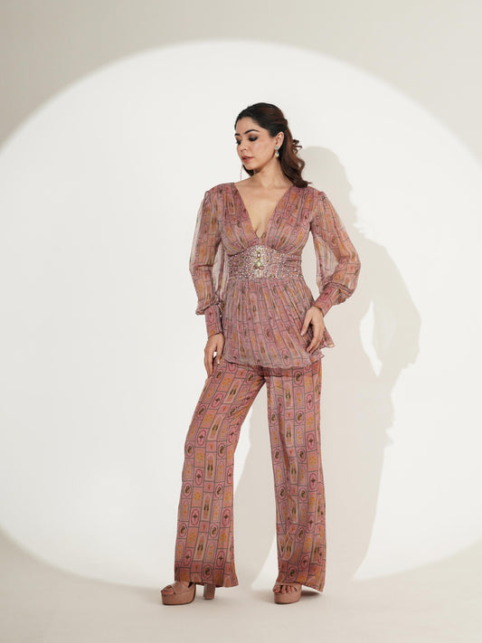 Full-length front view of blush pink peplum co-ord set with wide-leg trousers
