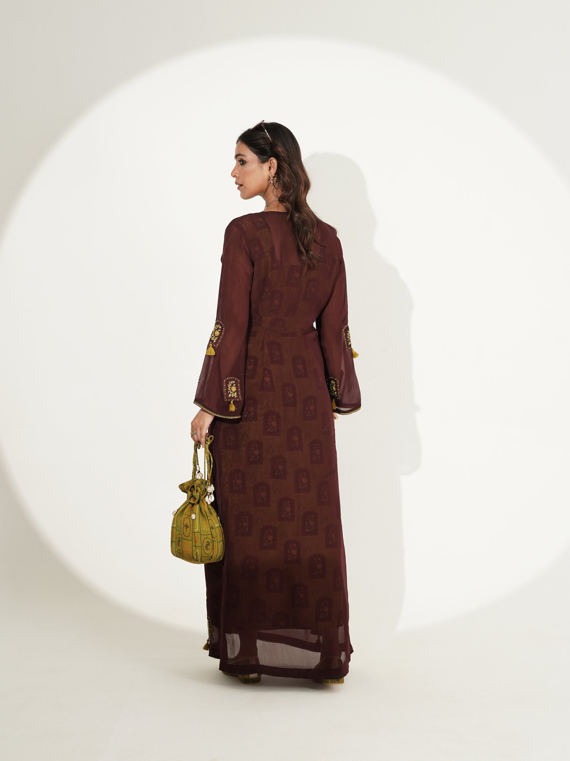 Deep brown longline kurta with flowing green skirt, side view