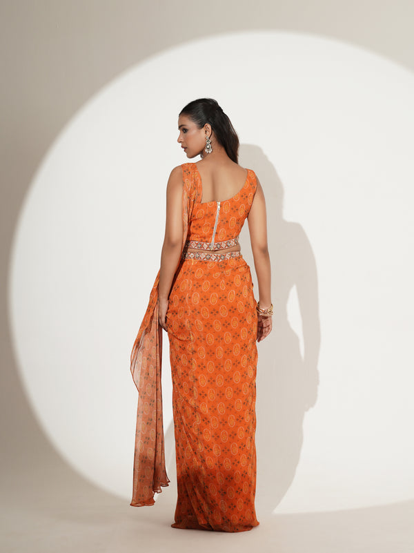 Orange one-shoulder saree set showing printed drape detail