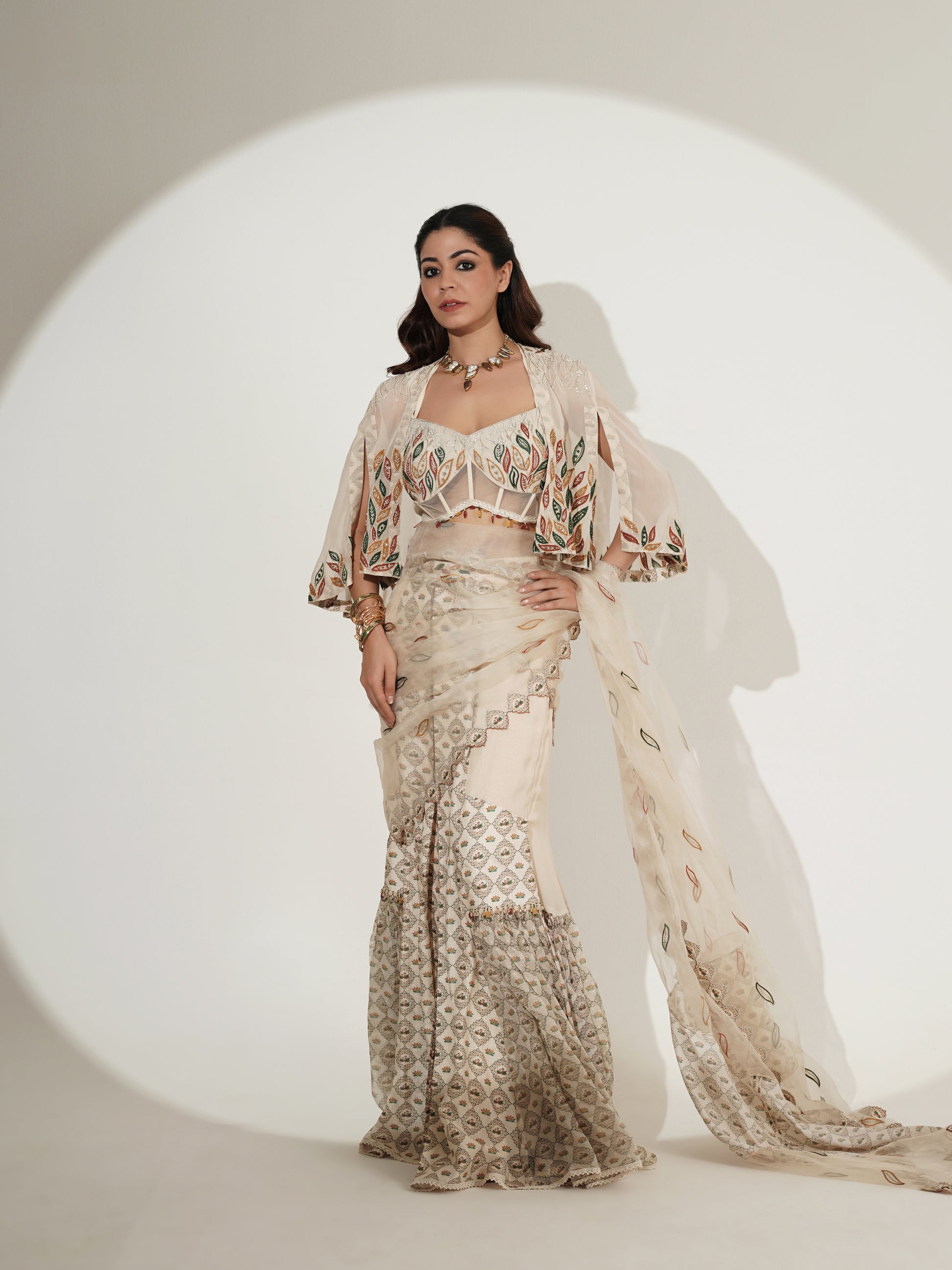 Beige printed lehenga with sheer cape, side view