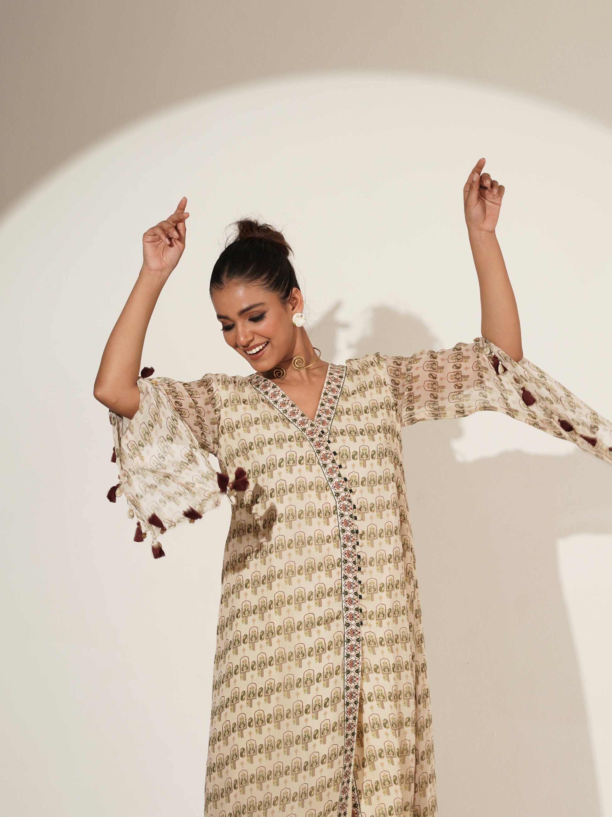 Beige Angrakha suit set showing coordinated printed-hem pants