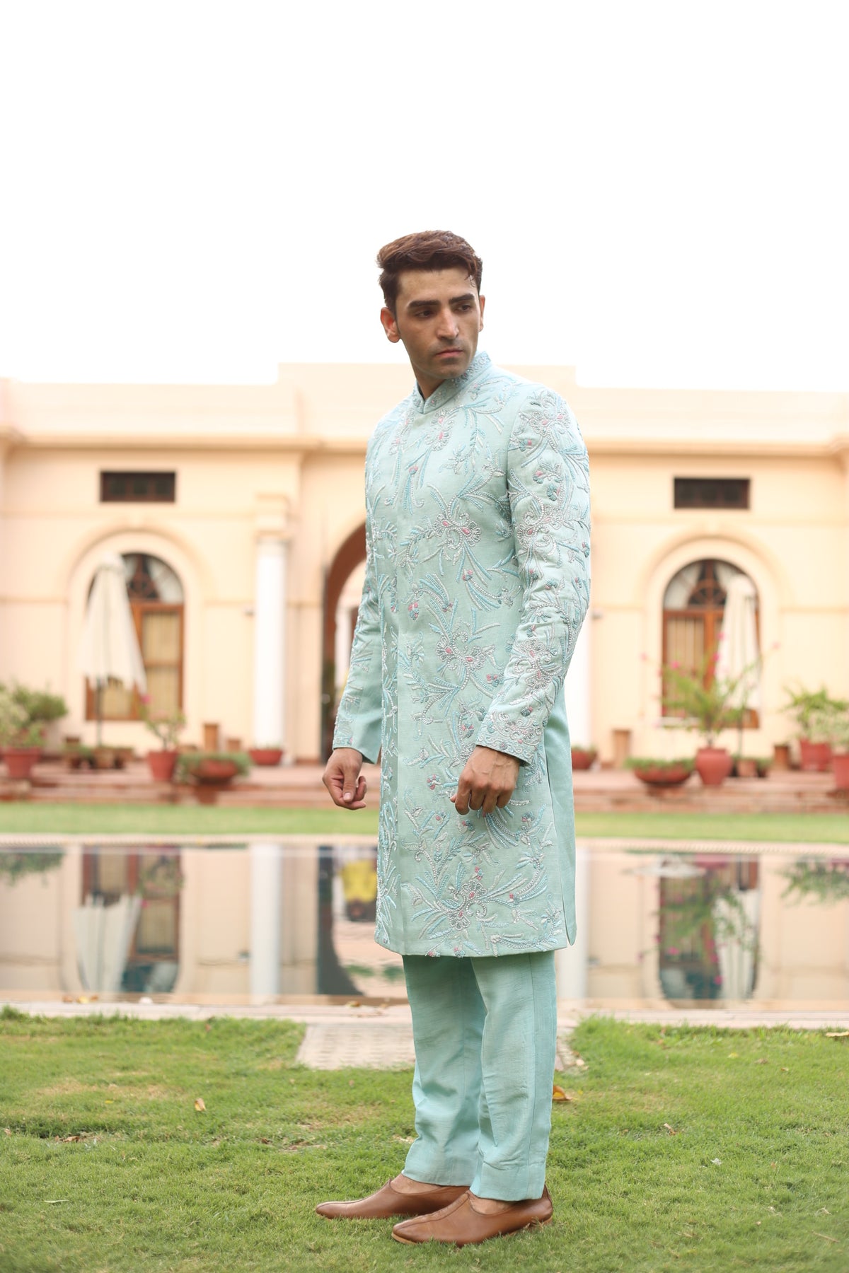 Pastel blue sherwani set showing floral embroidery detail